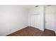 Bright bedroom featuring wood floors, white walls, and a closet for storage at 109 Montelluna Dr, North Venice, FL 34275