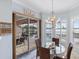 The breakfast nook overlooks the pool and has tile flooring, seating for 4 and a chandelier at 109 Montelluna Dr, North Venice, FL 34275