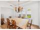 Formal dining room with a decorative chandelier, large dining table and chairs, and three arched windows at 109 Montelluna Dr, North Venice, FL 34275