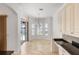 Bright dining area with chandelier, and slider to pool and patio, adjacent to kitchen at 109 Montelluna Dr, North Venice, FL 34275