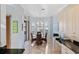 Dining area features chandelier, slider to pool and patio, and adjacent kitchen at 109 Montelluna Dr, North Venice, FL 34275