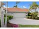 Charming home featuring a paver driveway, lush landscaping, and a two-car garage at 109 Montelluna Dr, North Venice, FL 34275