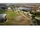 Scenic aerial view of the golf course, manicured green and surrounding community at 109 Montelluna Dr, North Venice, FL 34275