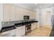 Bright kitchen features white cabinetry, stainless steel appliances and granite countertops at 109 Montelluna Dr, North Venice, FL 34275