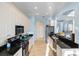 Stylish kitchen featuring white cabinets, black countertops, and stainless steel appliances at 109 Montelluna Dr, North Venice, FL 34275