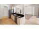 Kitchen features stainless steel appliances and bar top open to the living area, tile flooring at 109 Montelluna Dr, North Venice, FL 34275