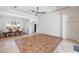 Spacious living room featuring tiled floors, ceiling fan, and open access to the dining room at 109 Montelluna Dr, North Venice, FL 34275
