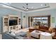 Inviting living room with comfortable seating, a large TV, and access to the outdoor patio at 109 Montelluna Dr, North Venice, FL 34275