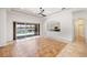 Open living room with tile flooring, fan and slider to pool and patio, adjacent to the kitchen at 109 Montelluna Dr, North Venice, FL 34275
