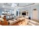 Bright living room with tray ceilings, tile floors, and an open floor plan to the dining room at 109 Montelluna Dr, North Venice, FL 34275