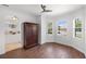 Cozy office space with wood floors, ceiling fan, and view into the front yard at 109 Montelluna Dr, North Venice, FL 34275