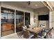 Outdoor patio features patio seating and dining, a ceiling fan, and a view of the lake at 109 Montelluna Dr, North Venice, FL 34275