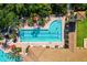 Aerial view of community pools surrounded by lush landscaping and lounge chairs at 109 Montelluna Dr, North Venice, FL 34275