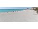 Expansive sandy beach with clear blue waters and beachgoers enjoying a sunny day at 1100 Tarpon Center Dr # 102B, Venice, FL 34285