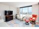 Inviting living room with a large window showcasing ocean views, seating and modern decor at 1100 Tarpon Center Dr # 102B, Venice, FL 34285