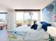 Tranquil bedroom with access to the beach and featuring coastal-inspired decor and furniture at 1100 Tarpon Center Dr # 102B, Venice, FL 34285