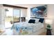 Bright bedroom with sliding glass doors to the beach and an ocean-themed decor and furniture at 1100 Tarpon Center Dr # 102B, Venice, FL 34285