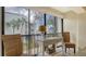 Cozy balcony with seating, a view of palm trees, and a decorative side table at 1130 Bird Bay Way # 184, Venice, FL 34285
