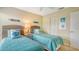 Bedroom featuring twin beds, beach themed decorations, and neutral walls at 1130 Bird Bay Way # 184, Venice, FL 34285