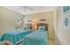 Twin beds in bedroom with beach theme decor and wicker headboards at 1130 Bird Bay Way # 184, Venice, FL 34285