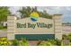 Entrance to Bird Bay Village is beautifully landscaped with colorful flowers at 1130 Bird Bay Way # 184, Venice, FL 34285