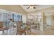 Cozy dining area with vaulted ceilings, stylish woven furniture, and serene natural light at 1130 Bird Bay Way # 184, Venice, FL 34285