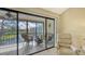 Relaxing screened lanai with seating, offering beautiful views of the tranquil pond at 1130 Bird Bay Way # 184, Venice, FL 34285