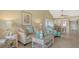 Inviting living room with a relaxed vibe, showcasing a comfortable sofa, charming decor, and easy access to the kitchen at 1130 Bird Bay Way # 184, Venice, FL 34285