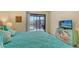 Cozy main bedroom with a television and view of the screened balcony at 1130 Bird Bay Way # 184, Venice, FL 34285