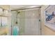 Modern shower featuring glass doors, white tile, and chrome fixtures at 1130 Bird Bay Way # 184, Venice, FL 34285