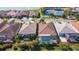 Aerial view of home with screened pool, landscaping, with lake and tennis court in background at 11700 Tapestry Ln, Venice, FL 34293