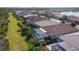 Backyard aerial view of multiple homes with swimming pools and lush green lawns at 11700 Tapestry Ln, Venice, FL 34293