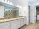 Bright bathroom with granite countertops, dual sinks, and a glass-enclosed shower at 11700 Tapestry Ln, Venice, FL 34293