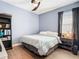 Bedroom with a queen size bed, dark accents, natural lighting and laminate floors at 11700 Tapestry Ln, Venice, FL 34293