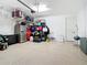 Garage featuring a white door, epoxy floor, storage area, overhead storage and a utility sink at 11700 Tapestry Ln, Venice, FL 34293