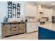 Charming kitchen featuring custom cabinets, stainless appliances, granite counters, and wood-look tile flooring at 11700 Tapestry Ln, Venice, FL 34293