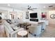 Bright living room with neutral furniture, ceiling fan and built-in cabinets at 11700 Tapestry Ln, Venice, FL 34293