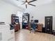 The home office features a ceiling fan, a printer/copier, desk and a laminate floor at 11700 Tapestry Ln, Venice, FL 34293