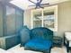 Covered patio corner, with weather protection, featuring outdoor seating, a grill, and a storage box at 11700 Tapestry Ln, Venice, FL 34293