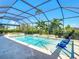 Relaxing screened-in pool area with sun-lounging chairs for luxurious outdoor living at 11700 Tapestry Ln, Venice, FL 34293