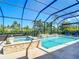 Stunning screened-in pool with spa, perfect for relaxation and outdoor entertainment, surrounded by lush landscaping and privacy at 11700 Tapestry Ln, Venice, FL 34293