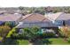 Aerial view of a private screened in pool and spa, surrounded by lush landscaping, next to a lake at 11700 Tapestry Ln, Venice, FL 34293