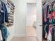 Spacious walk-in closet with custom shelving and organization for clothes and shoes at 11700 Tapestry Ln, Venice, FL 34293