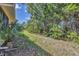 Lush backyard with tropical foliage creating a private and serene outdoor space at 121 Auburn Woods Cir, Venice, FL 34292