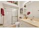 Bright bathroom featuring a glass-enclosed shower, white vanity, and tile flooring at 121 Auburn Woods Cir, Venice, FL 34292