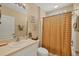 Bathroom with a shower with curtain, white sink, and framed artwork at 121 Auburn Woods Cir, Venice, FL 34292