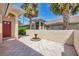 Attractive home featuring a tiled courtyard with palm trees, a covered entrance, and a wall offering privacy at 121 Auburn Woods Cir, Venice, FL 34292