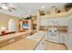 Open kitchen featuring white appliances, a breakfast bar with seating, and views into the dining area at 121 Auburn Woods Cir, Venice, FL 34292