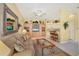 Open living area featuring built-in shelving, a comfortable sofa, and a breakfast bar with seating at 121 Auburn Woods Cir, Venice, FL 34292