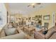 Spacious living room with comfortable seating, decorative rug, and view to dining and kitchen at 121 Auburn Woods Cir, Venice, FL 34292